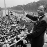 Featured & Cover Martin Luther King Jr waves to supporters on August 28 1963 during the March on Washington for Jobs and Freedom on the Mall in Washington D C Activists marked 60 years since